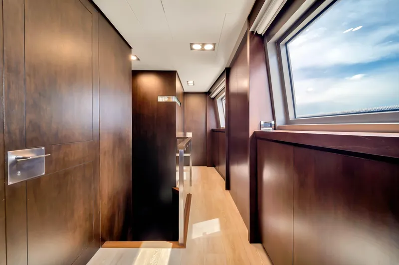Slide: The Image of Luxurious interior hallway of 2012 Azimut 116 yacht with wooden paneling and large windows. - 29