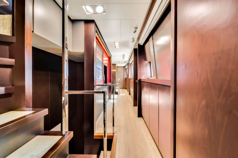 Slide: The Image of Luxurious interior hallway of a 2012 Azimut 116 yacht with elegant wood finishes. - 30