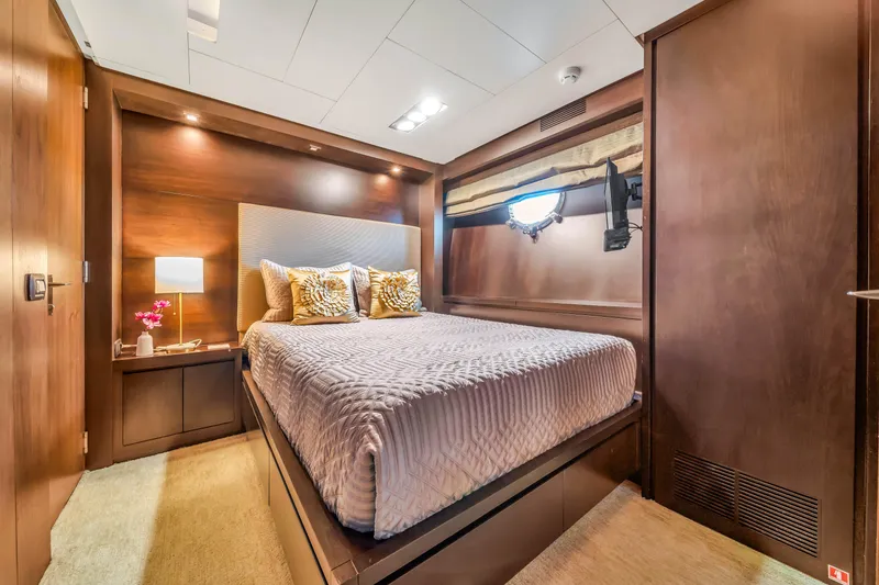 Slide: The Image of Luxurious bedroom interior on 2012 Azimut 116 yacht, featuring elegant wood finishes and cozy bedding. - 35