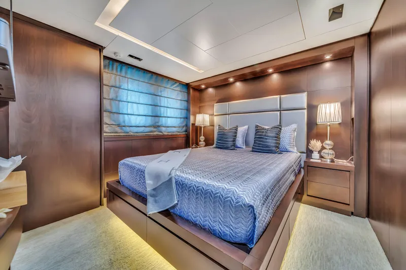 Slide: The Image of Luxurious bedroom interior on a 2012 Azimut 116 yacht, featuring elegant wood paneling. - 47