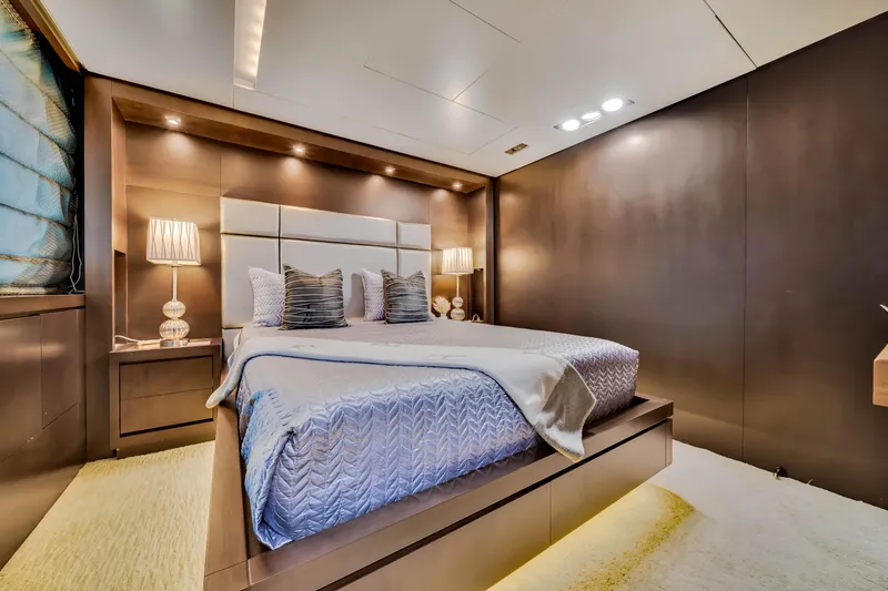 Slide: The Image of Luxurious bedroom interior on a 2012 Azimut 116 yacht, featuring elegant lighting and modern decor. - 49