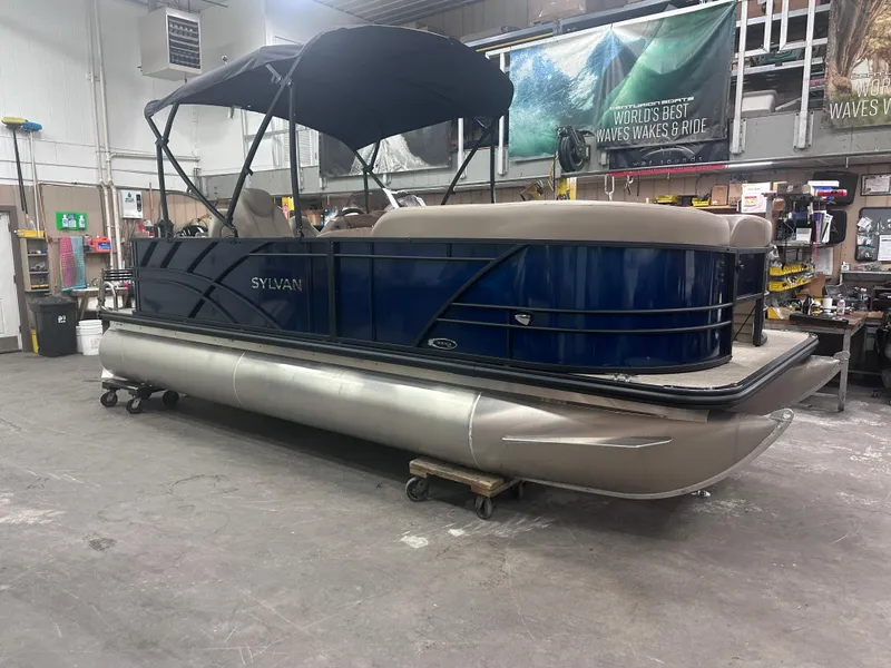 The Image of 2025 Sylvan Mirage Fish 820 Party Fish pontoon boat in a workshop setting. - 0