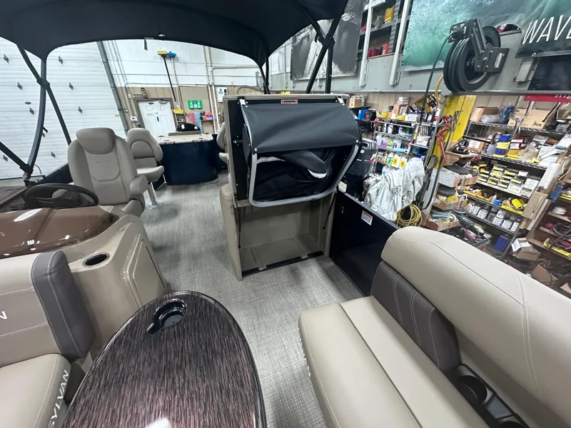 Slide: The Image of 2025 Sylvan Mirage Fish 820 Party Fish interior in a workshop setting. - 2