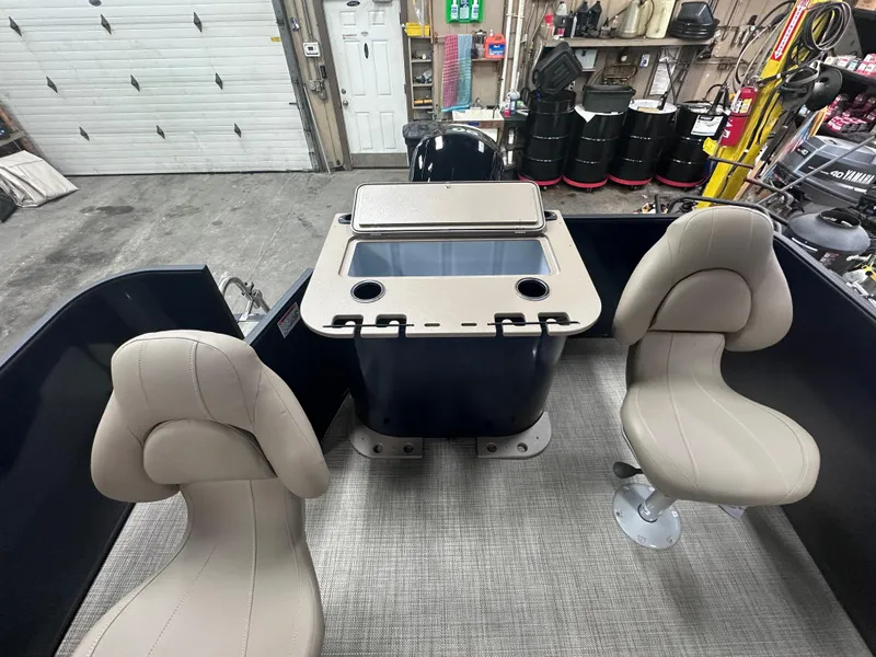 Slide: The Image of 2025 Sylvan Mirage Fish 820 Party Fish interior with beige seats and fishing station. - 4