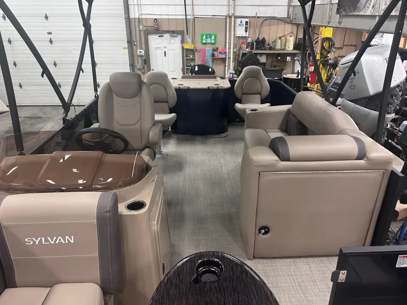 Slide: The Image of 2025 Sylvan Mirage Fish 820 Party Fish interior with beige seating and steering console. - 7