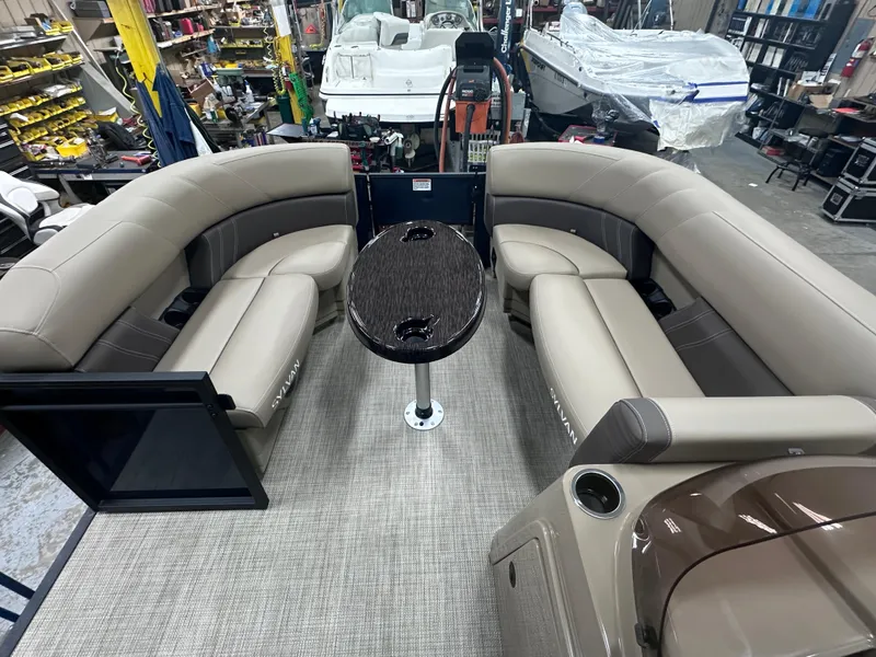 Slide: The Image of 2025 Sylvan Mirage Fish 820 Party Fish boat interior with plush seating and central table. - 9