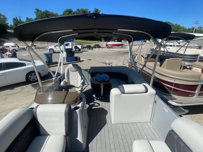 Slide: The Image of 2025 Sylvan Mirage 818 Cruise pontoon boat with spacious seating and canopy in a marina. - 5