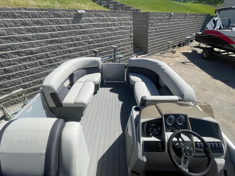 Slide: The Image of 2025 Sylvan Mirage 818 Cruise pontoon boat interior with plush seating and modern dashboard. - 6