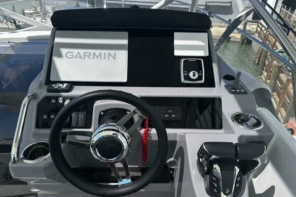 Slide: The Image of 2024 Jeanneau Leader 9.0 WA helm with Garmin navigation system and controls. - 10