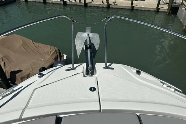Slide: The Image of 2024 Jeanneau Leader 9.0 WA boat bow with anchor, docked in marina. - 12