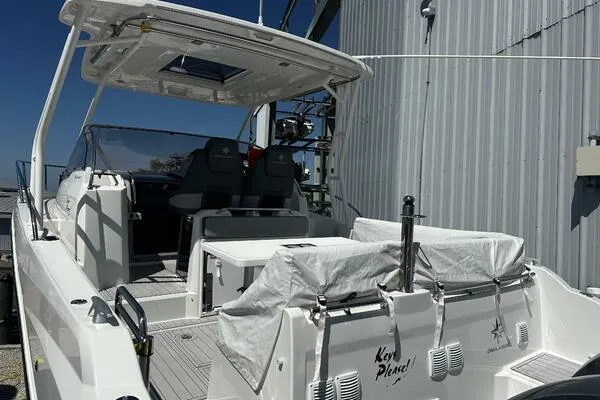 Slide: The Image of 2024 Jeanneau Leader 9.0 WA boat docked, featuring spacious deck and modern design. - 18