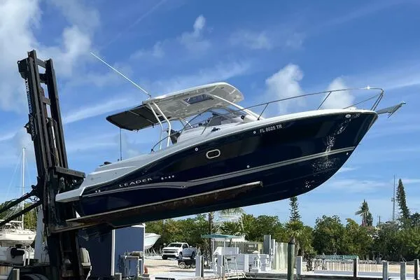 Slide: The Image of 2024 Jeanneau Leader 9.0 WA boat lifted by forklift at marina. - 3