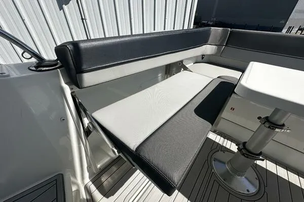 Slide: The Image of 2024 Jeanneau Leader 9.0 WA boat seating area with sleek black and white upholstery. - 31