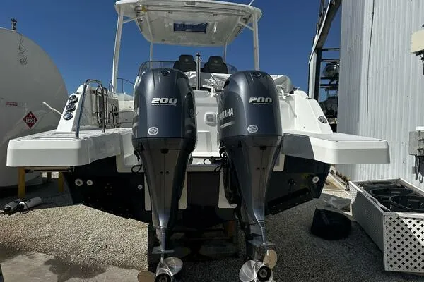 Slide: The Image of 2024 Jeanneau Leader 9.0 WA with twin Yamaha 200 engines, docked outdoors. - 4