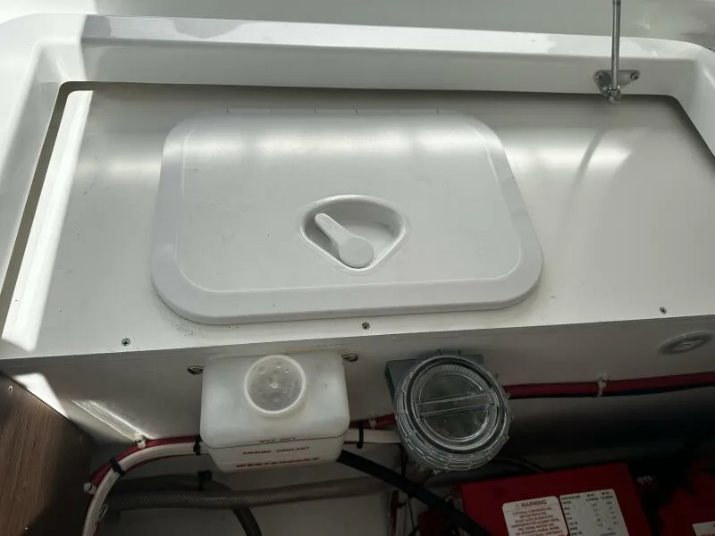 Slide: The Image of 2024 Jeanneau Leader 9.0 WA boat compartment with storage lid and wiring. - 44
