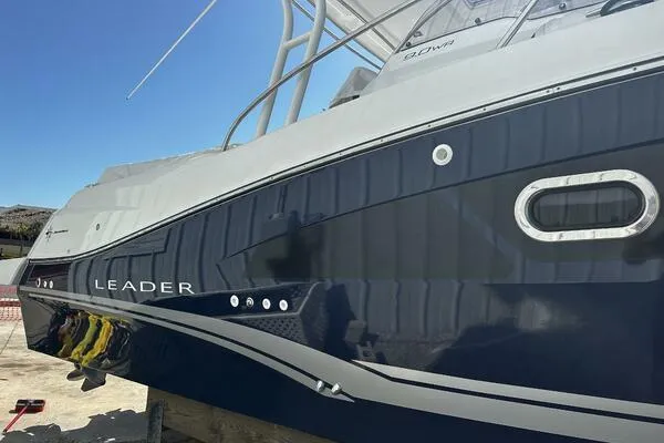 Slide: The Image of 2024 Jeanneau Leader 9.0 WA boat, sleek design, docked under clear blue sky. - 6