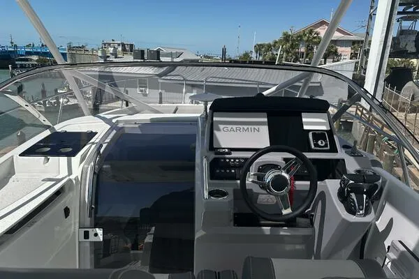 Slide: The Image of 2024 Jeanneau Leader 9.0 WA boat cockpit with Garmin navigation system. - 9