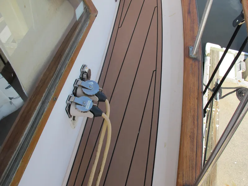 Slide: The Image of 1984 Monk 36 boat deck with wood trim and cable connections. - 10