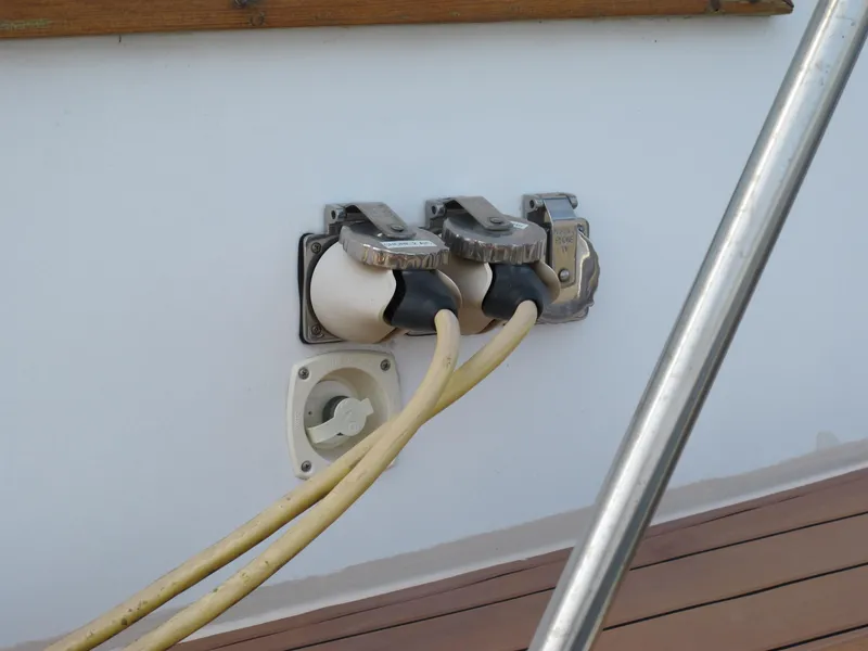 Slide: The Image of Electrical outlets on 1984 Monk 36 boat with yellow cables connected. - 11