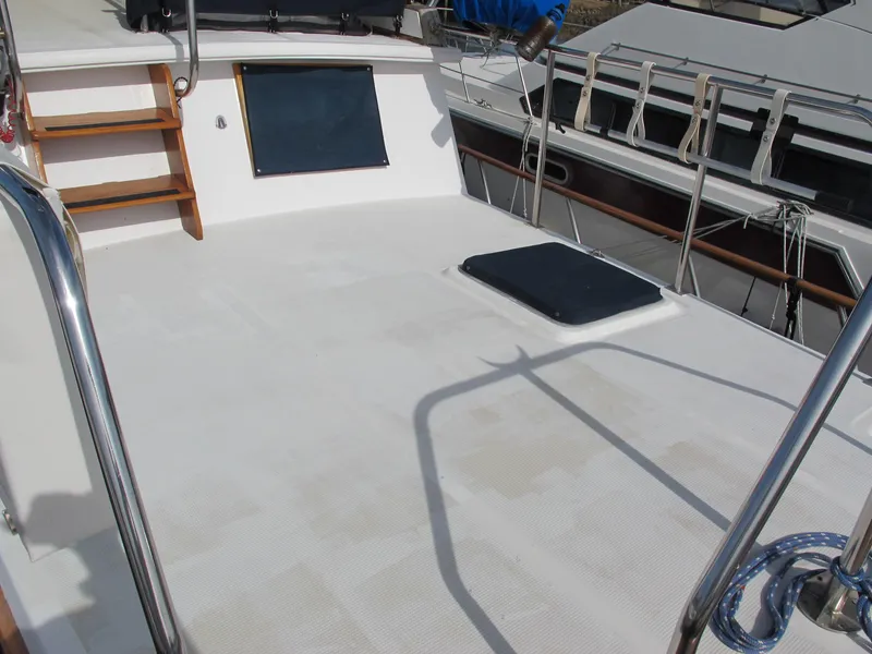 Slide: The Image of Deck of a 1984 Monk 36 boat with wooden steps and railing. - 12