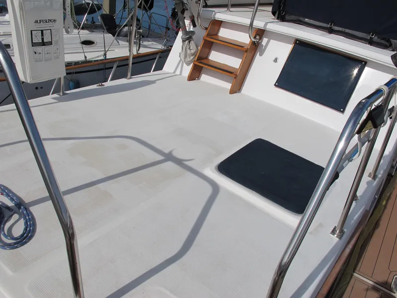 Slide: The Image of 1984 Monk 36 boat deck with seating and railing, featuring a clean, spacious layout. - 13