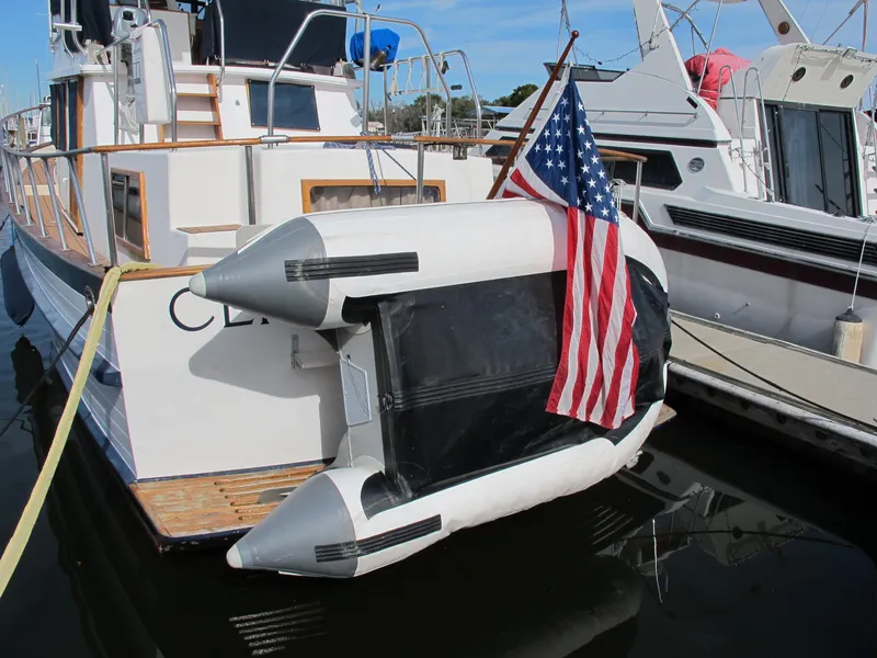 Slide: The Image of Inflatable dinghy with American flag attached to a 1984 Monk 36 boat. - 17