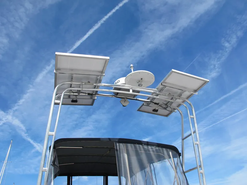 Slide: The Image of Solar panels on a 1984 Monk 36 boat under a clear blue sky. - 18