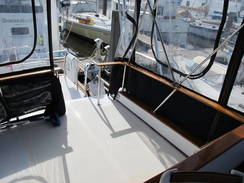 Slide: The Image of 1984 Monk 36 yacht deck with seating and marina view. - 25