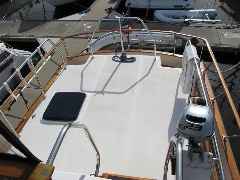 Slide: The Image of 1984 Monk 36 yacht deck with railing and motor at marina. - 26