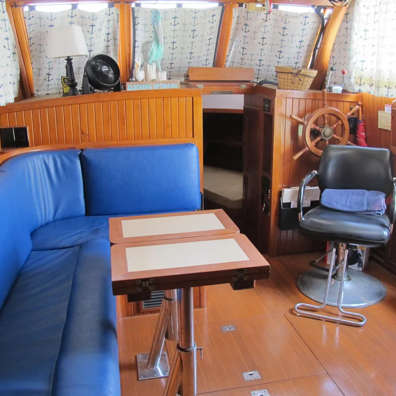Slide: The Image of Interior of a 1984 Monk 36 boat with blue seating and wooden accents. - 29