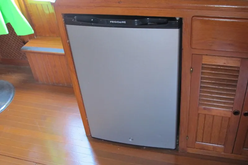 Slide: The Image of Frigidaire refrigerator in 1984 Monk 36 boat interior, wooden cabinetry. - 46