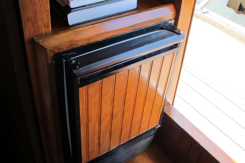 Slide: The Image of Wooden interior detail of a 1984 Monk 36 boat, featuring a compact cabinet. - 47