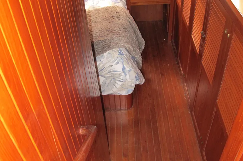 Slide: The Image of Wood-paneled cabin interior of 1984 Monk 36 boat with bed and hallway. - 49