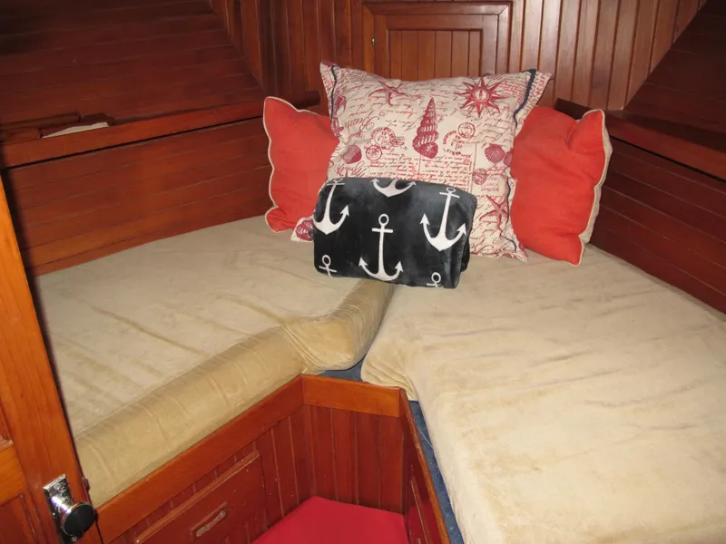 Slide: The Image of Cozy cabin interior of 1984 Monk 36 boat with nautical-themed pillows. - 62