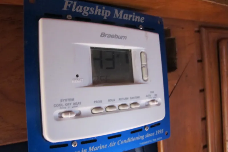 Slide: The Image of Thermostat on a 1984 Monk 36 boat, displaying temperature, mounted on a wooden panel. - 64