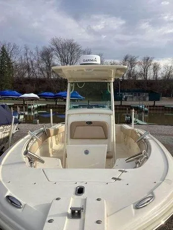 Slide: The Image of 2013 Scout 245 XFS boat with Garmin equipment, docked near a marina. - 1