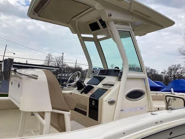 Slide: The Image of 2013 Scout 245 XFS boat cockpit with steering wheel and controls. - 2