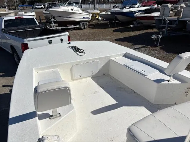 Slide: The Image of 2022 May-Craft 22 Hancock Skiff boat interior with white seating and storage compartments. - 12