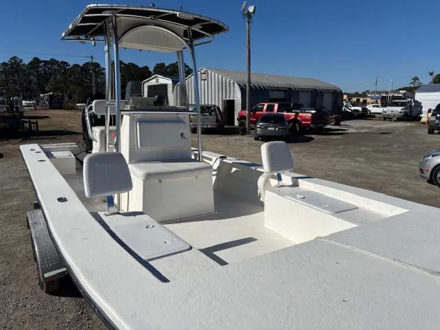 Slide: The Image of 2022 May-Craft 22 Hancock Skiff boat in a parking lot, featuring a spacious deck. - 8