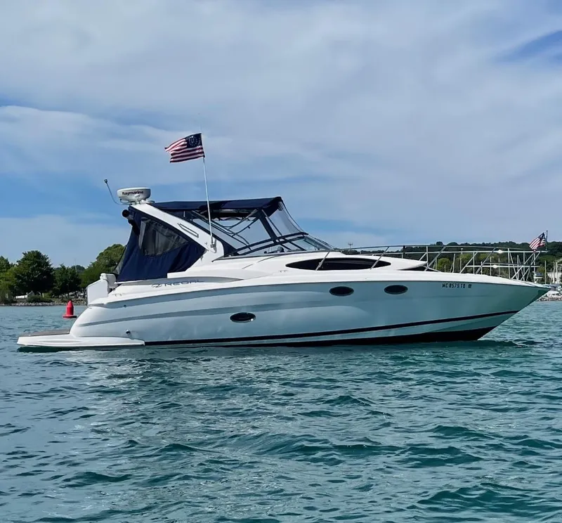 The Image of 2008 Regal 3360 Window Express boat on water, American flag, clear sky. - 0