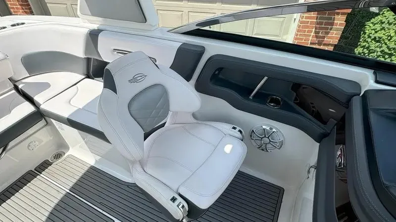 Slide: The Image of 2019 Chaparral 257 SSX boat interior with white seating and modern design. - 11
