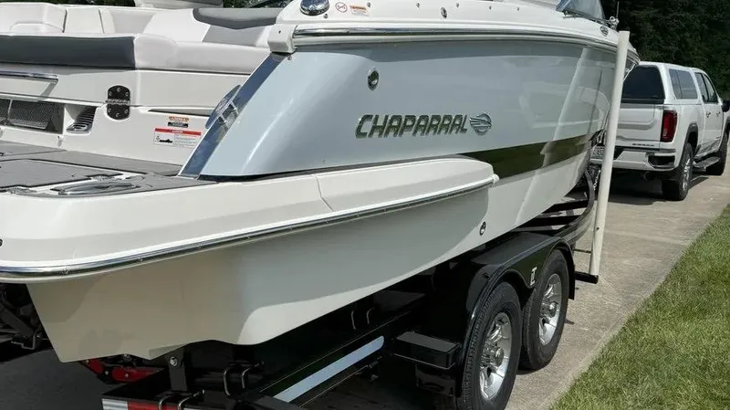 Slide: The Image of 2019 Chaparral 257 SSX boat on trailer, parked beside a white truck. - 12