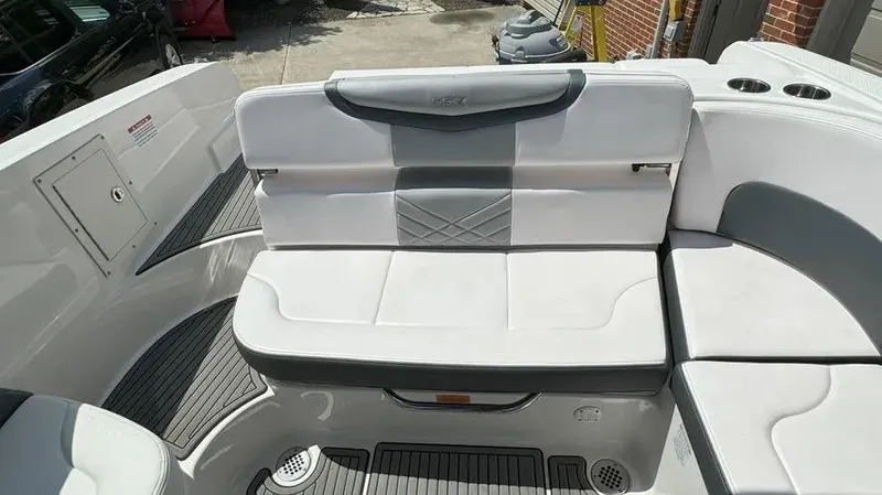 Slide: The Image of 2019 Chaparral 257 SSX boat interior with white seating and gray accents. - 15