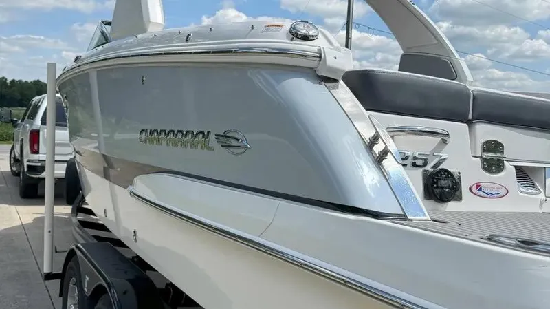 Slide: The Image of 2019 Chaparral 257 SSX boat on trailer, sleek design, sunny day. - 16