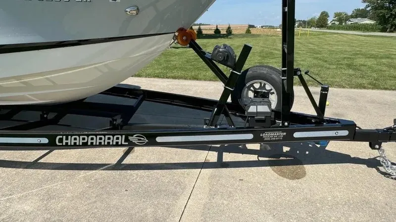 Slide: The Image of 2019 Chaparral 257 SSX boat on Loadmaster trailer, parked on concrete driveway. - 18