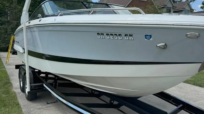 Slide: The Image of 2019 Chaparral 257 SSX boat on trailer, parked in driveway. - 2