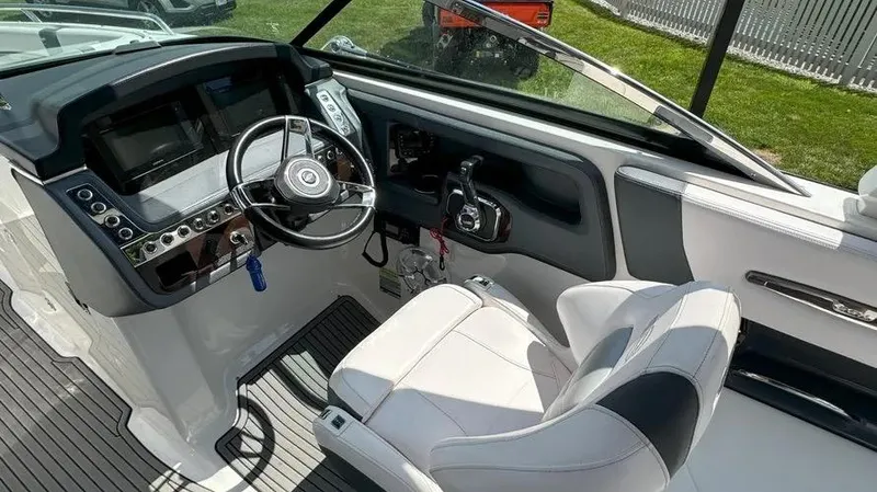 Slide: The Image of 2019 Chaparral 257 SSX boat cockpit with steering wheel and control panel. - 26