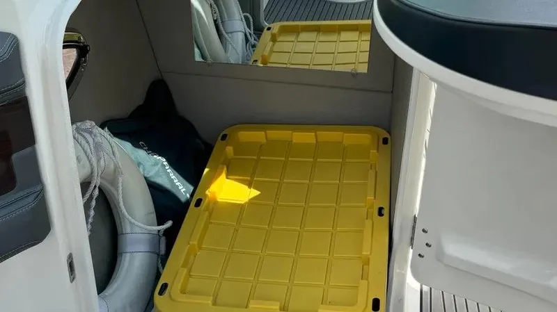 Slide: The Image of Interior of 2019 Chaparral 257 SSX boat with yellow storage bin and life jackets. - 29