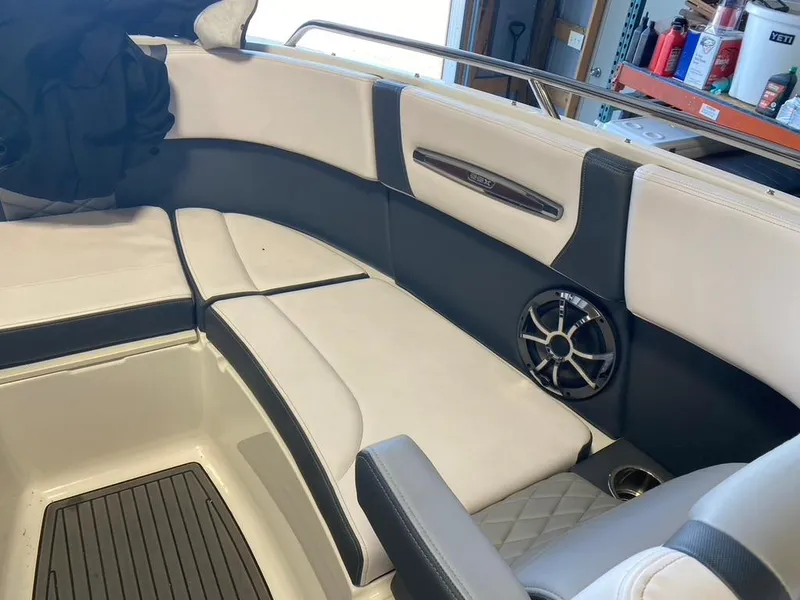 Slide: The Image of 2019 Chaparral 257 SSX boat interior with cushioned seating and speaker. - 33