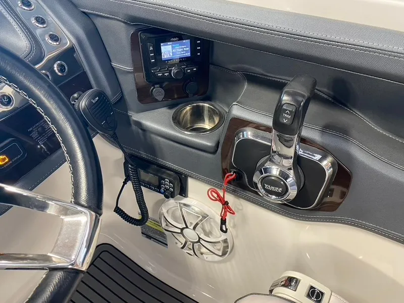 Slide: The Image of 2019 Chaparral 257 SSX boat dashboard with controls and audio system. - 34